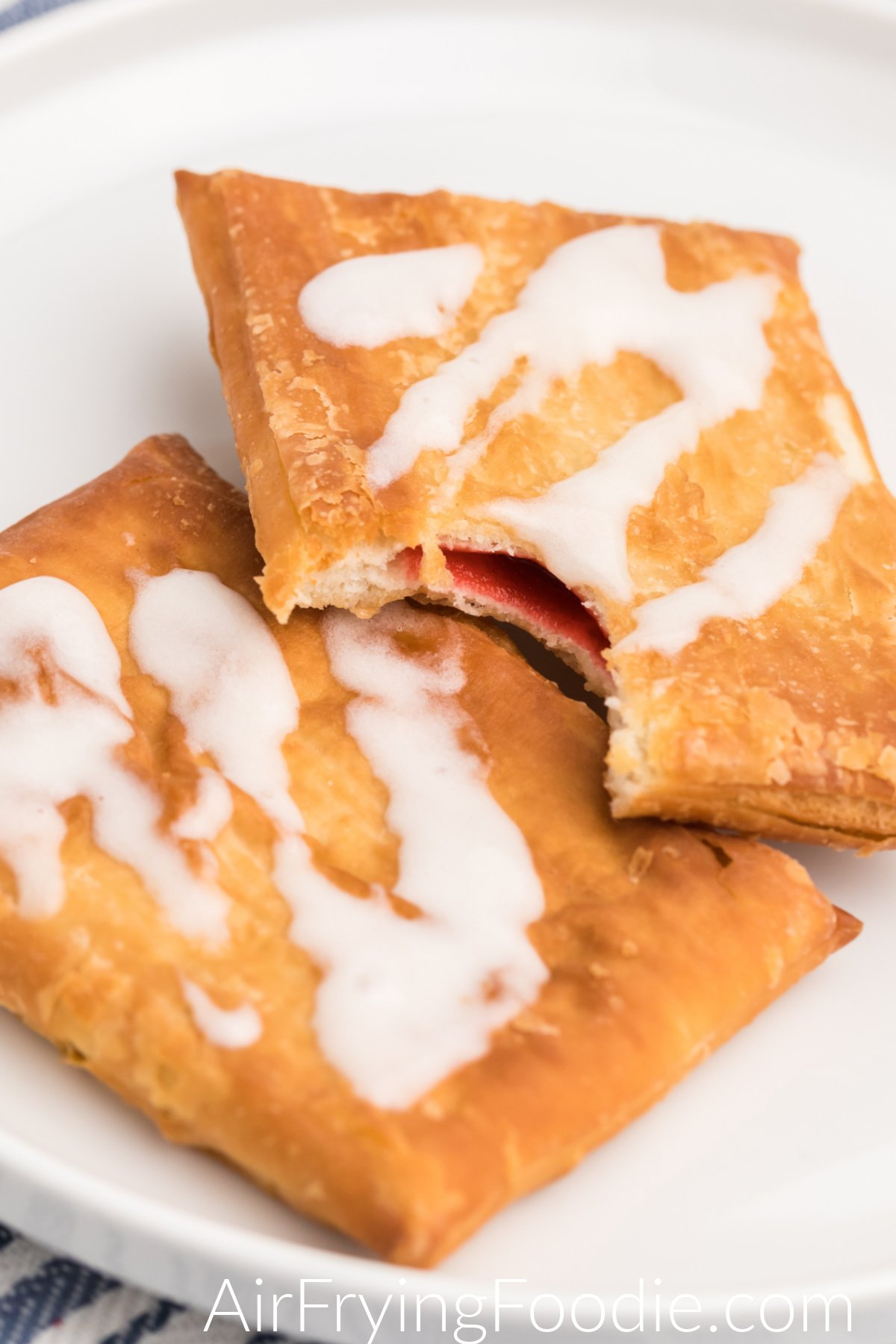Close up shot of toaster strudel on a plate with one having a missing bite.