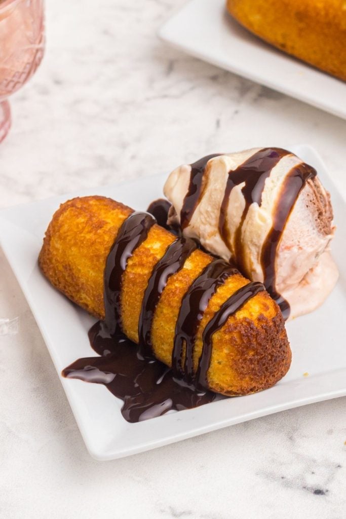 Golden crispy twinkie drizzled in chocolate sauce and served with a side of ice cream