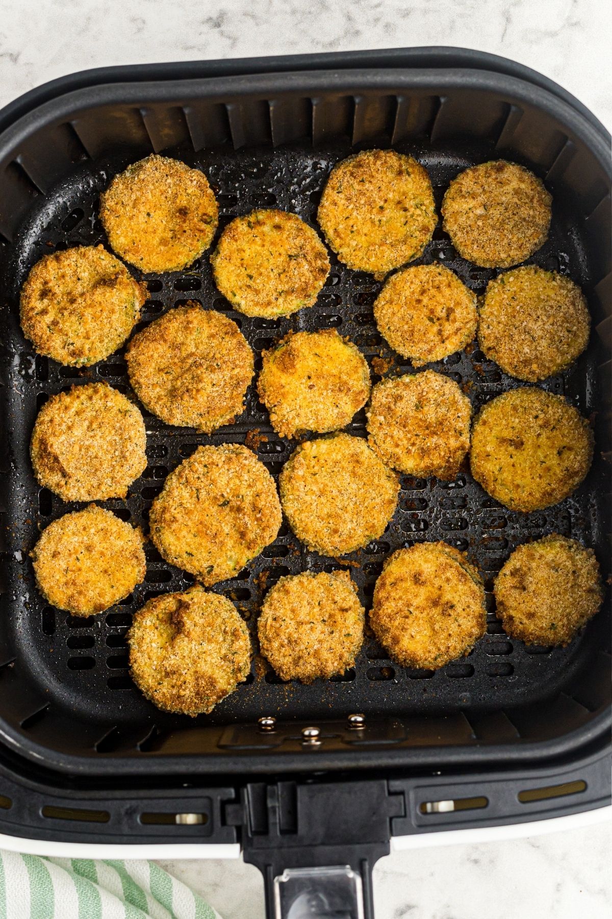 Golden crispy fried zucchini in the air fryer basket