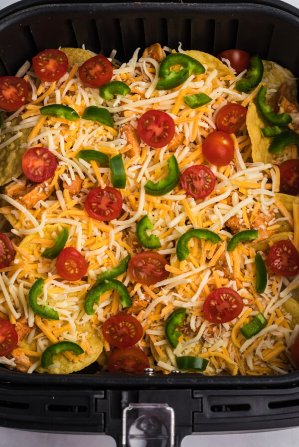 Loaded nachos in the basket of the air fryer