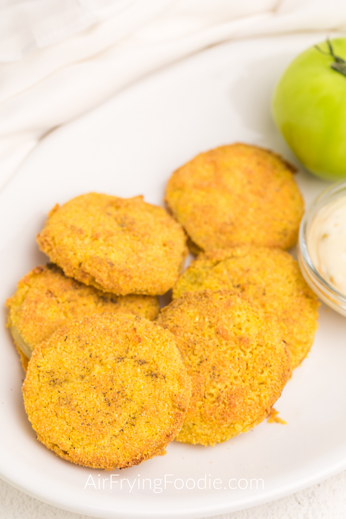 Air Fried Green Tomatoes on a white plate served with dipping sauce on the side. 