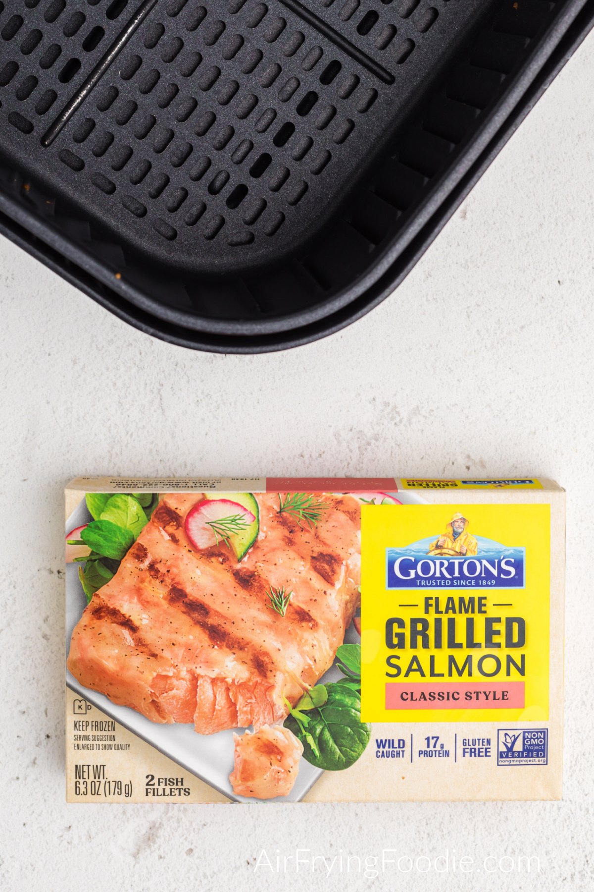 Air fryer basket and Gorton's flame grilled frozen salmon. 