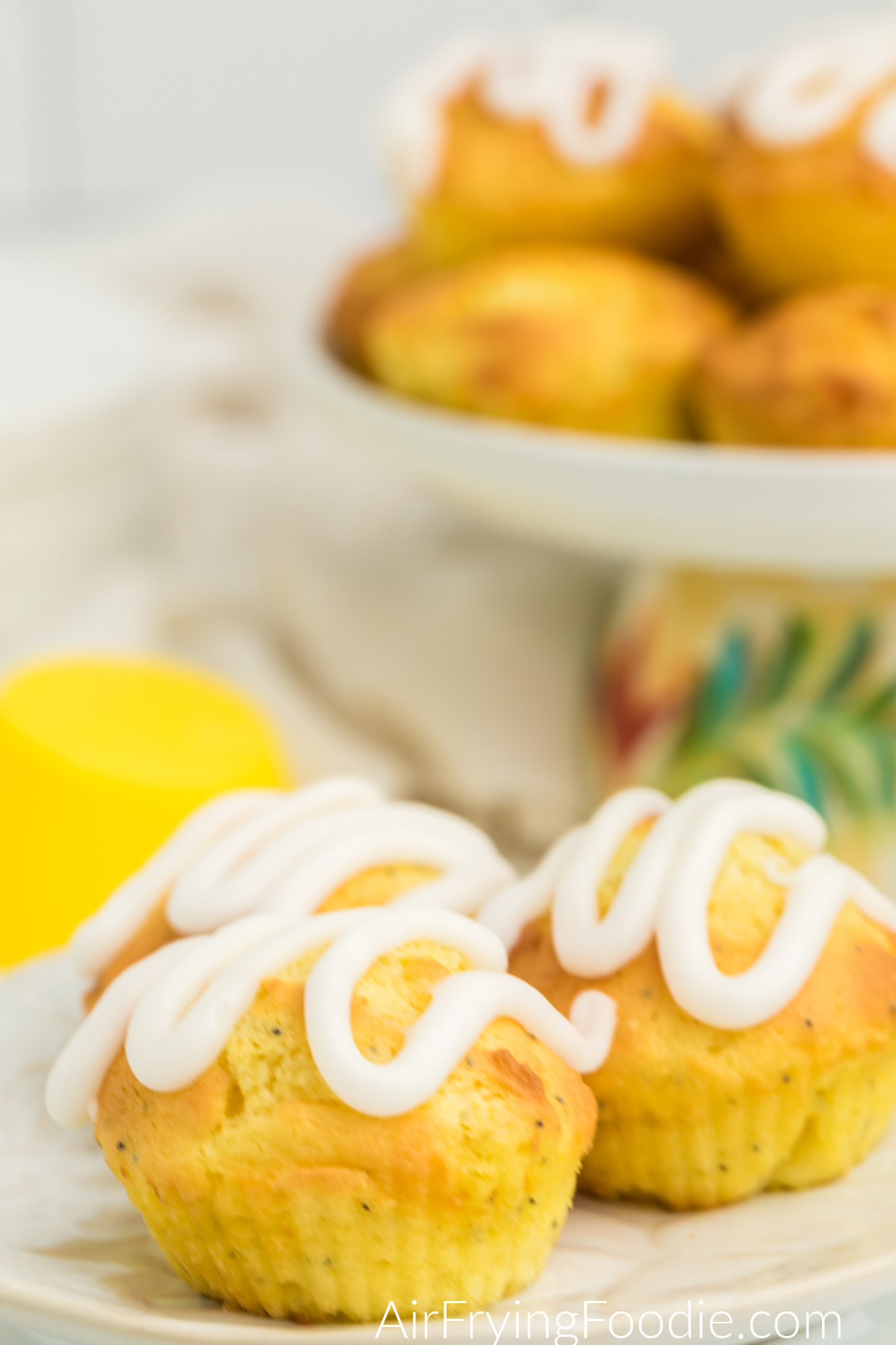 Lemon Poppy Seed Muffins with lemon glaze on a plate, ready to serve.