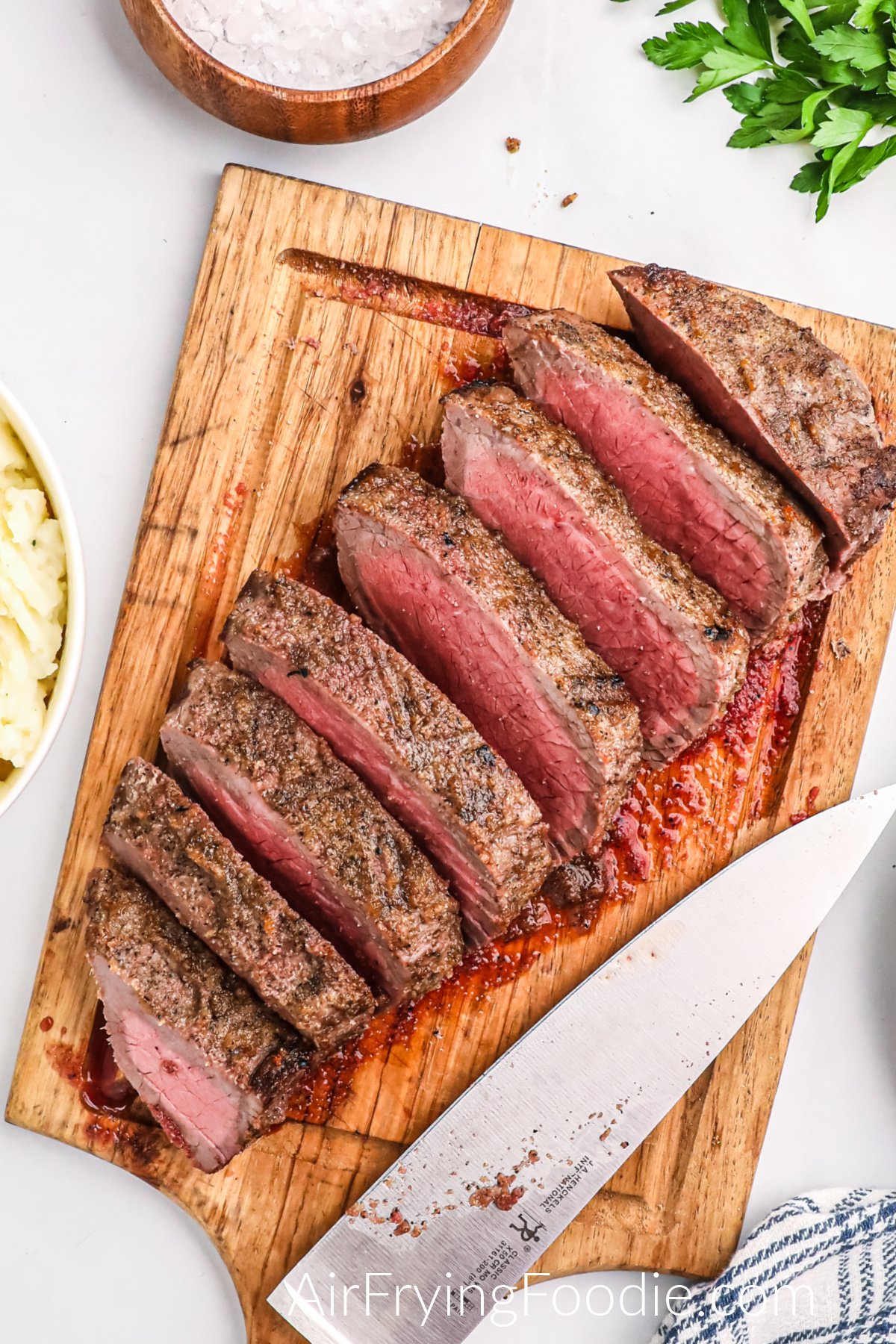 Air Fryer London Broil on a cutting board, sliced and ready to serve.