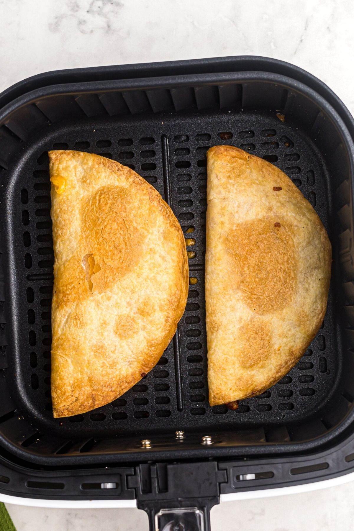 Crispy golden quesadillas in the air fryer basket