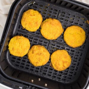 Overhead photo of air fried green tomatoes in the air fryer basket