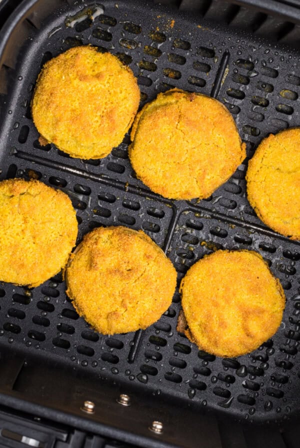 Overhead photo of air fried green tomatoes in the air fryer basket