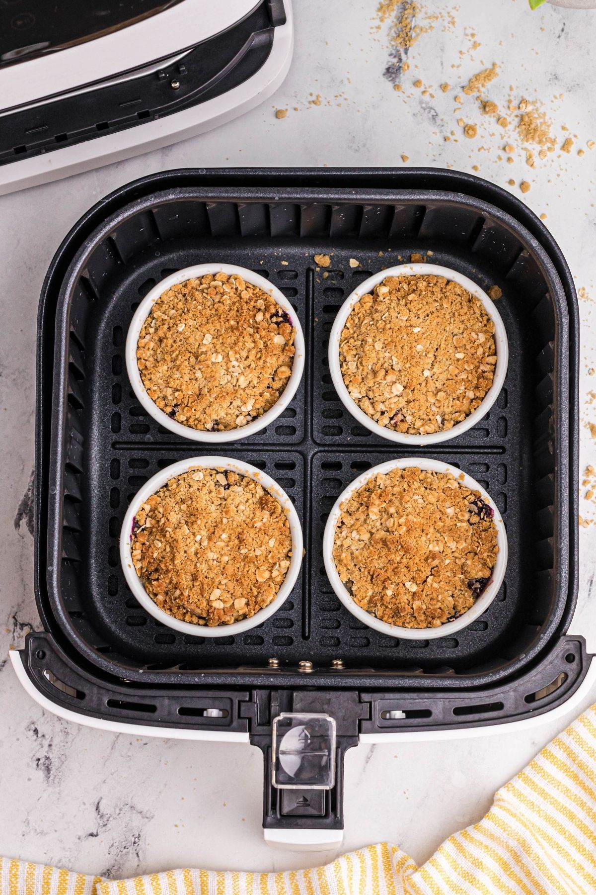 Golden crispy topped blueberry mixture in air fryer basket