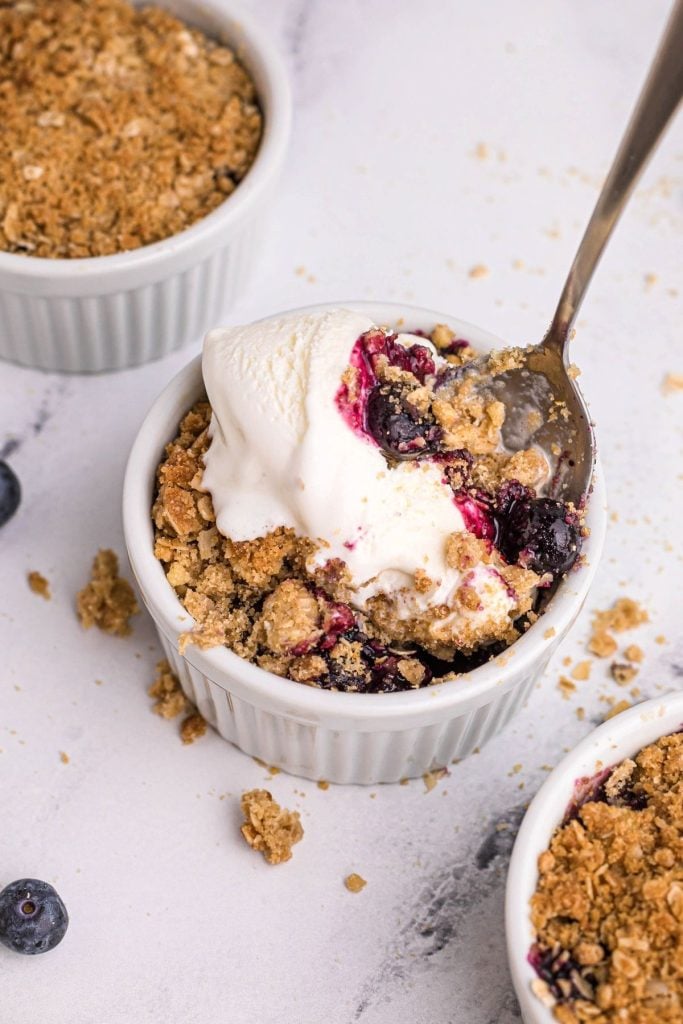 Ramekin filled with blueberry mixture topped with vanilla ice cream