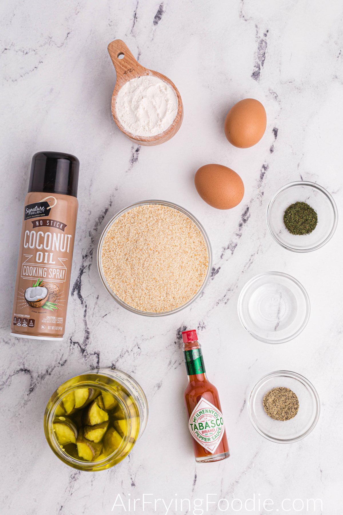 Ingredients laid out on a table that are needed to make fried dill pickles in the air fryer. 