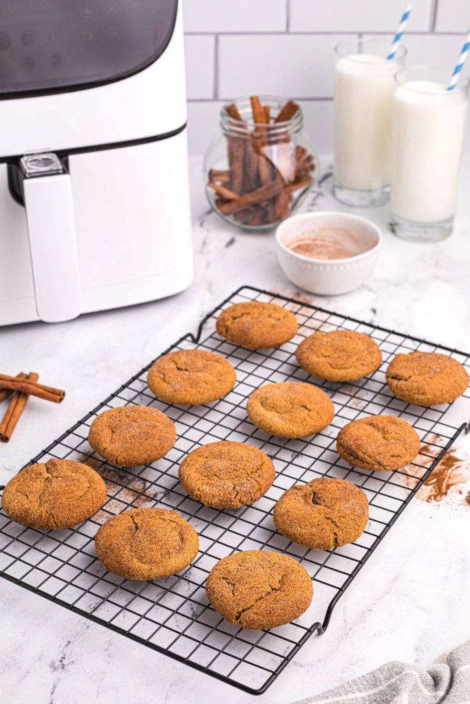 Gingersnap cookies on a cooling rack in front of the air fryer