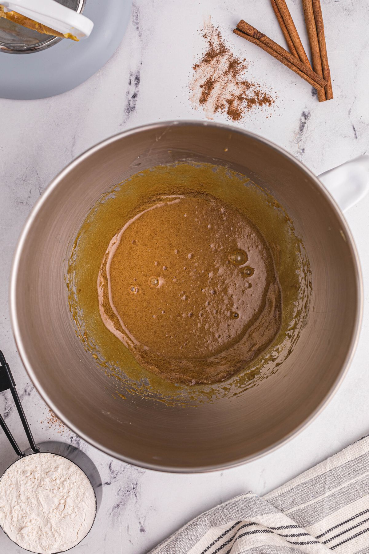 Gingersnap dough being mixed together in a silver mixing bowl