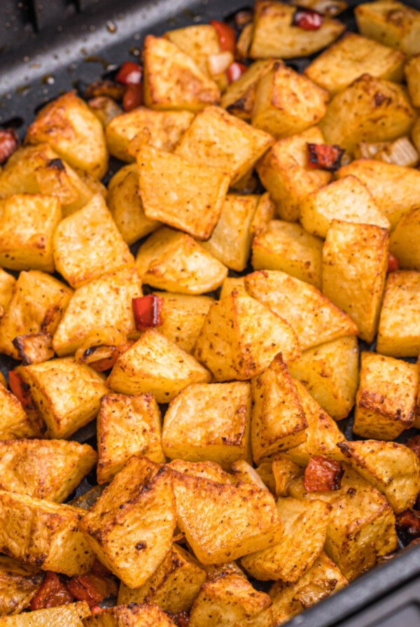 cooked home fries in the basket of the air fryer.