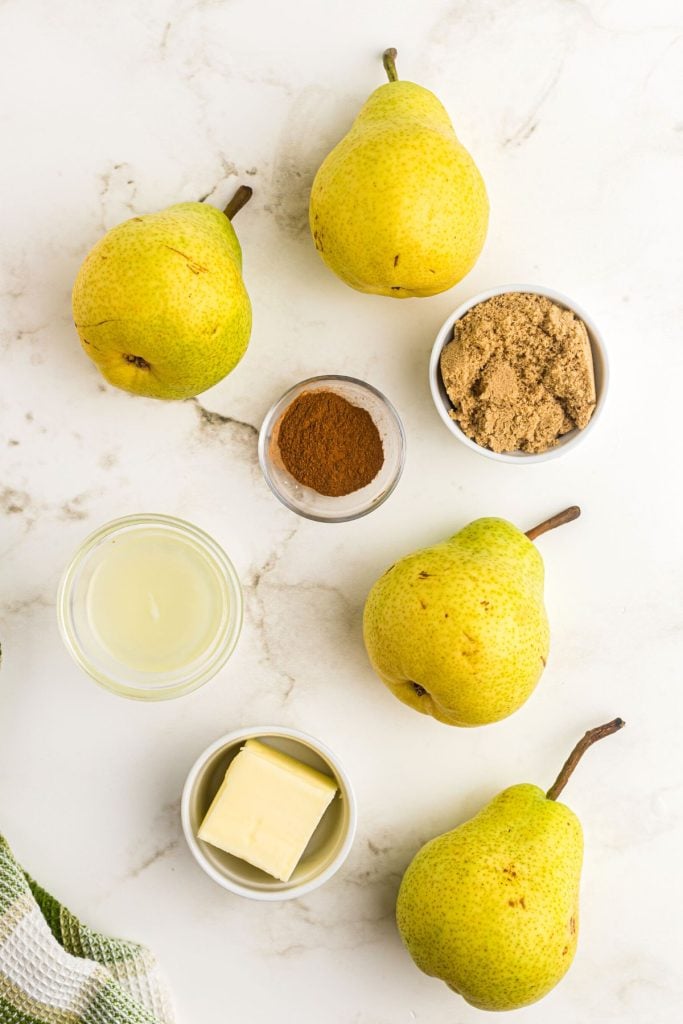 Ingredients to make air fryer pears on a white marble table