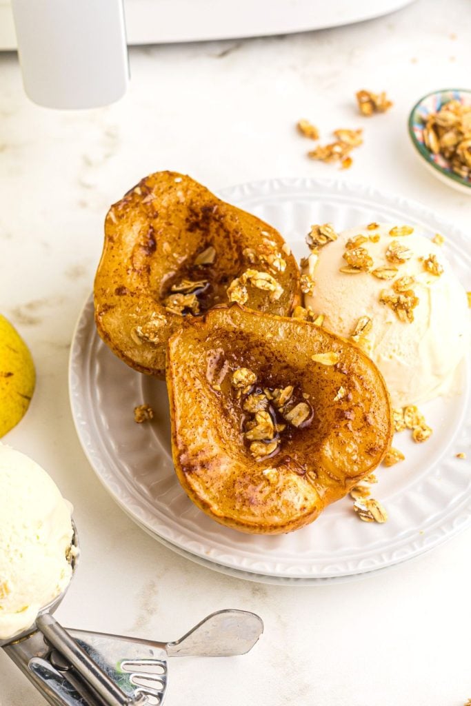 Golden juicy pears sliced and sprinkled with granola and served with vanilla ice cream. 
