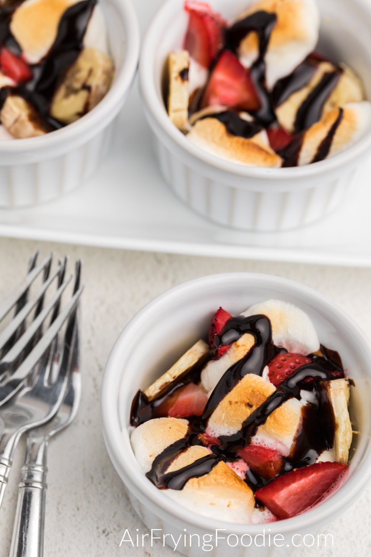 Strawberry Banana bowls made in the air fryer and drizlled with chocolate topping.