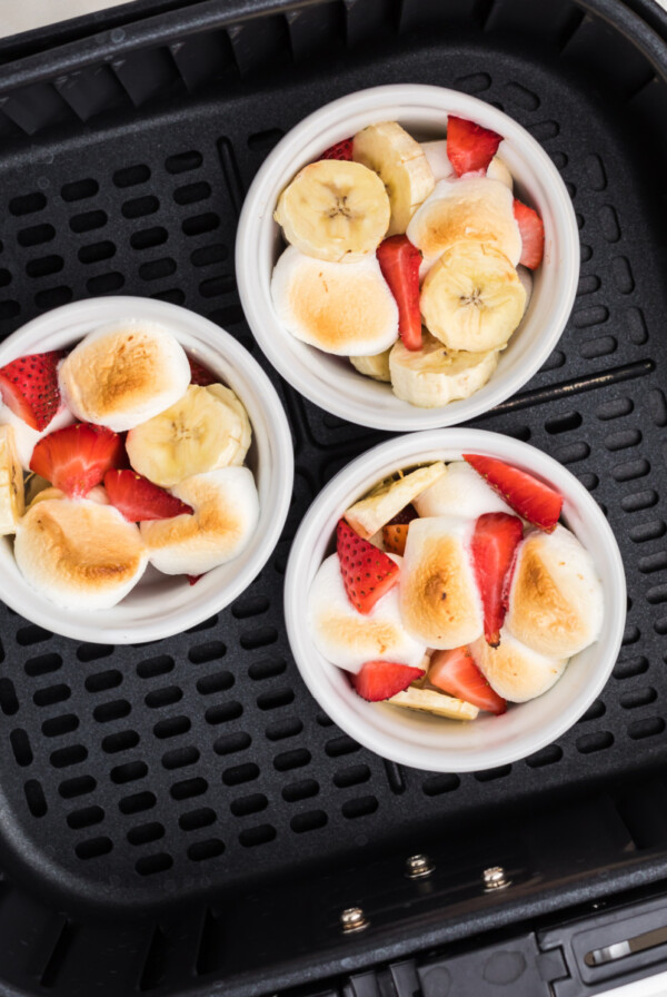 Strawberry Banana Bowls in the basket of the air fryer.