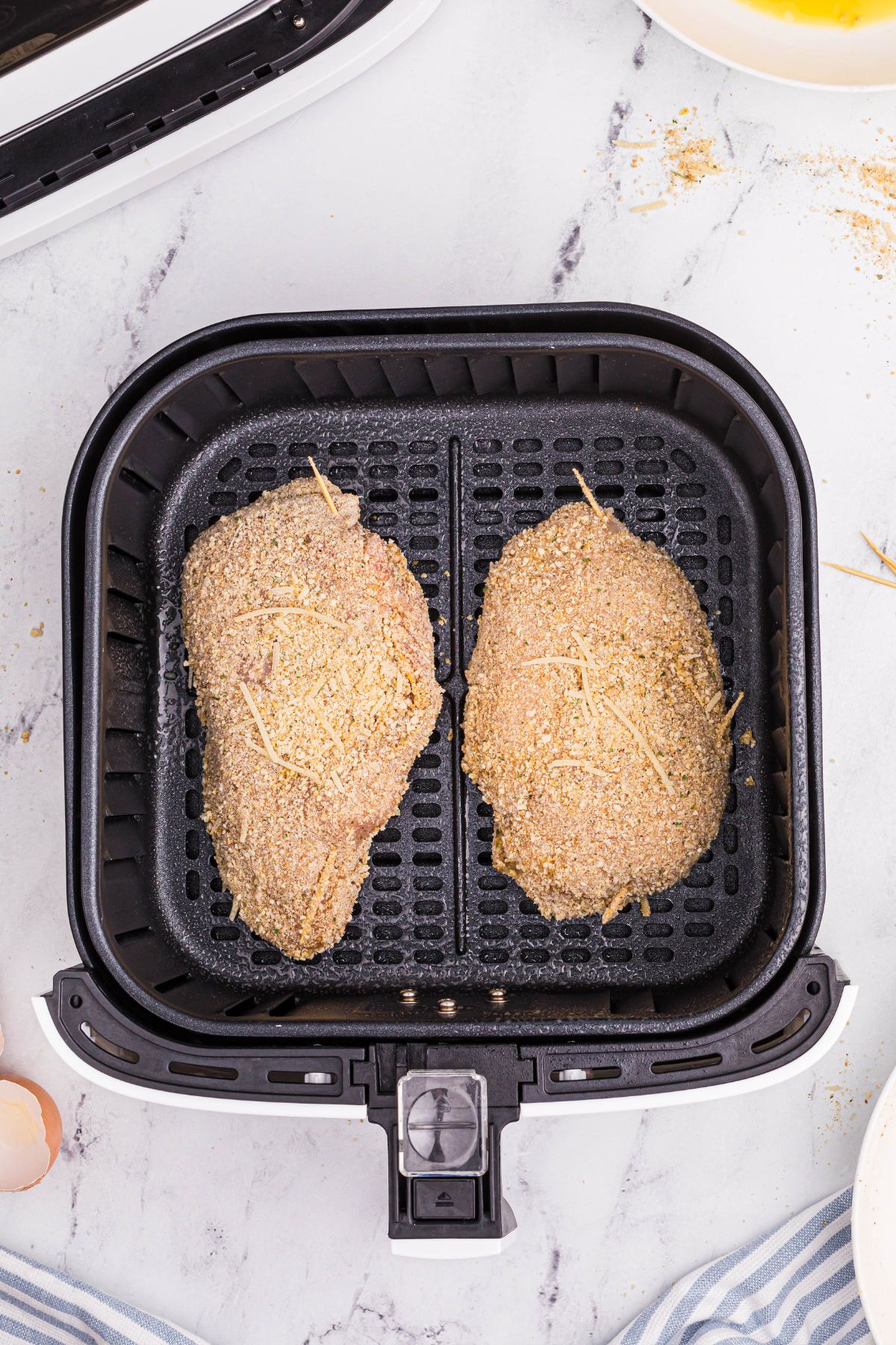 Breaded stuffed chicken breasts in the air fryer basket