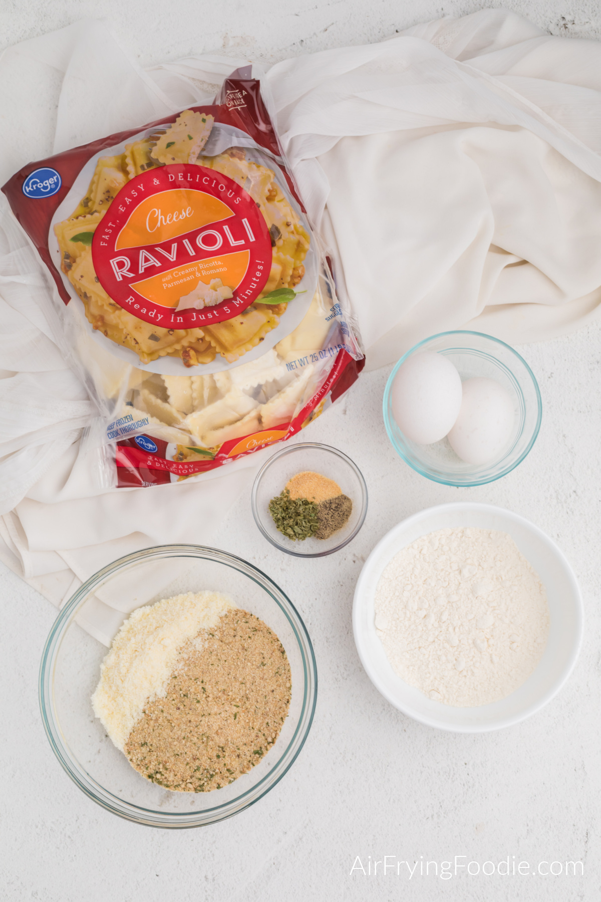 Frozen ravioli and ingredients needed to make fried ravioli in the air fryer.