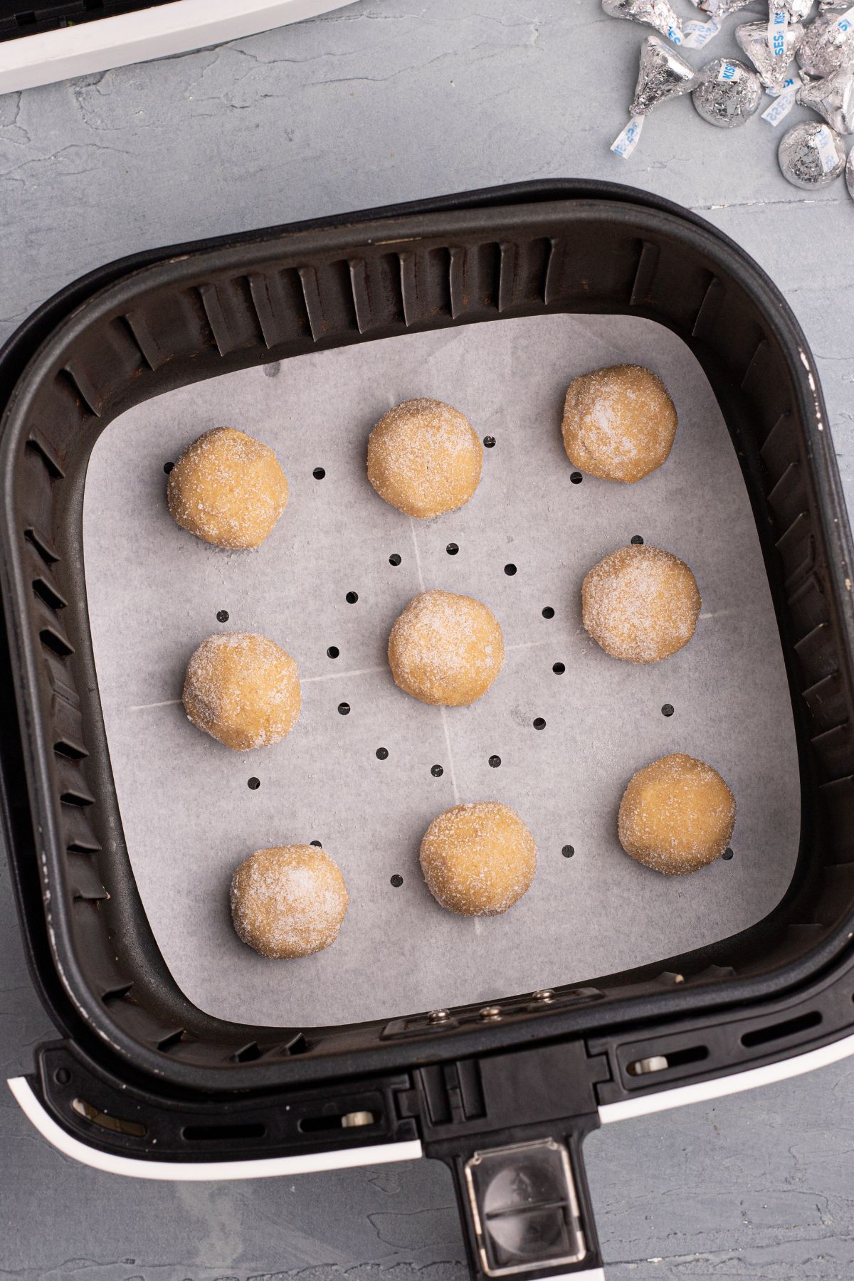Peanut butter dough balls in an air fryer basket