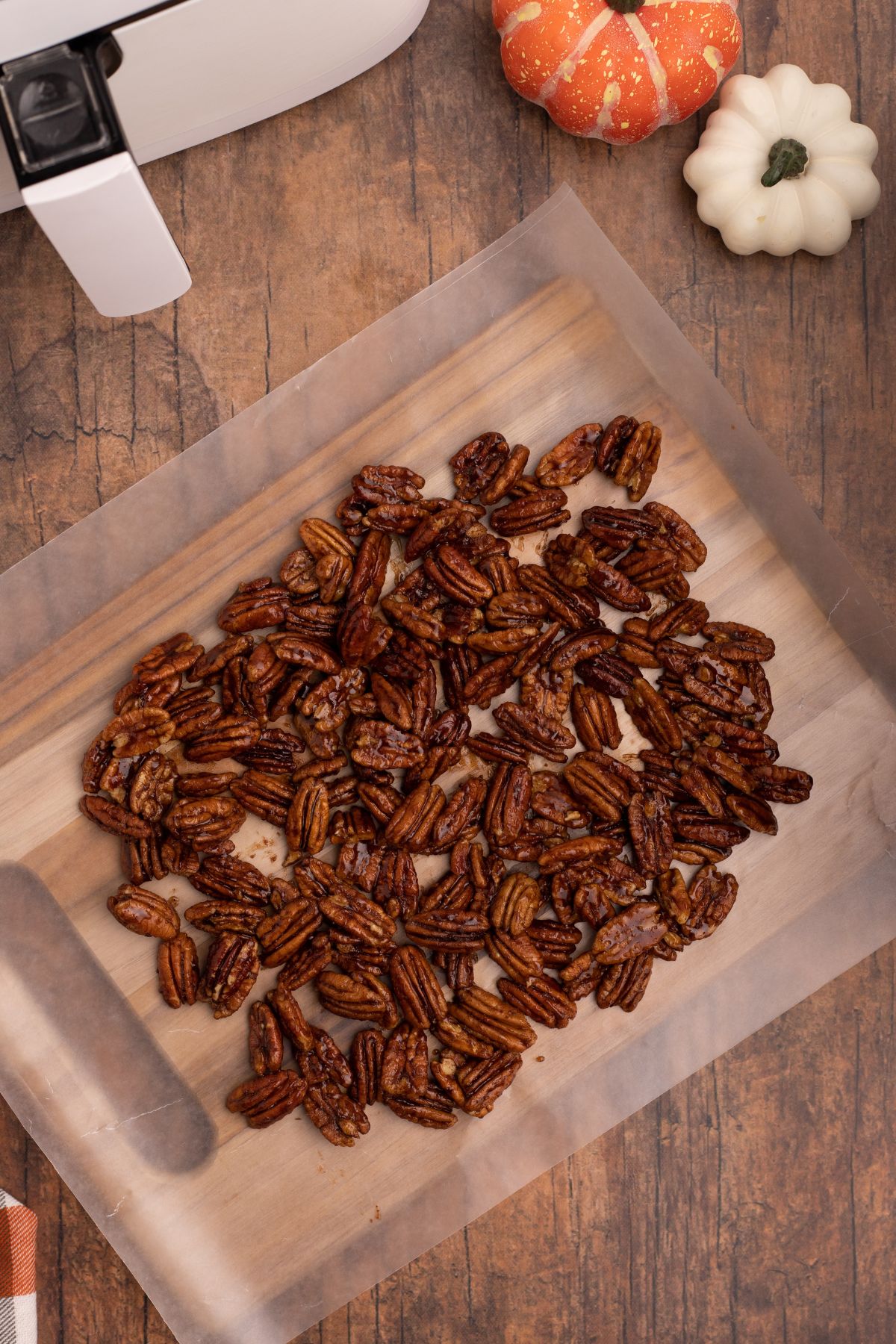 Pecans spread out on wax paper to dry out and cool