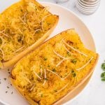 Overhead of spaghetti squash on a white plate, ready to serve.