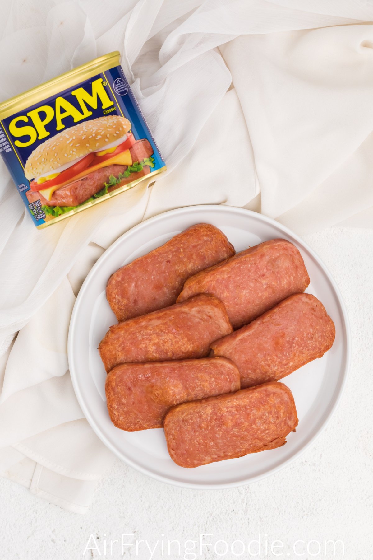 Air fried spam on a white plate ready to serve.
