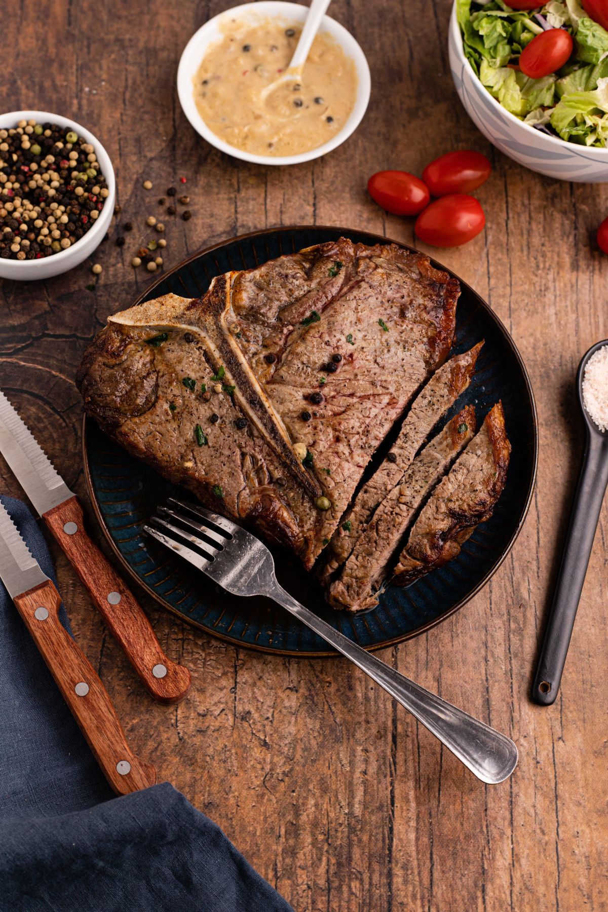 Juicy tbone steak on a black plate