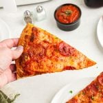 Golden crispy slice of pepperoni pizza after being cooked in the air fryer