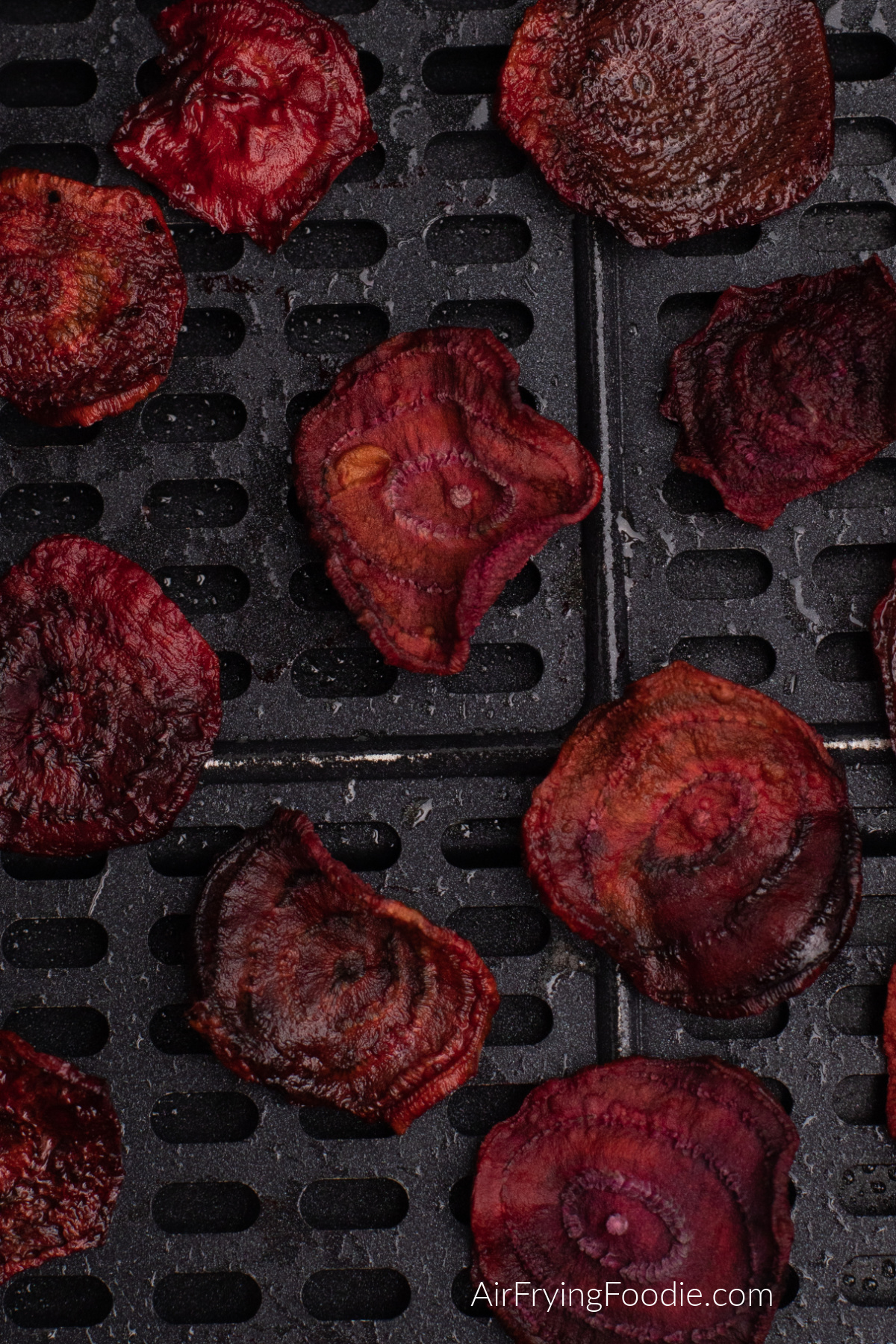 Beet chips cooked and in the basket of the air fryer.