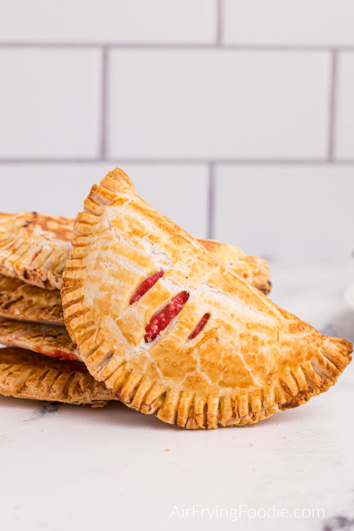 Stacked cream cheese cherry pies made in the air fryer and ready to eat. 