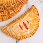 Cream Cheese Cherry pie made in the air fryer and on a white marble tabletop.