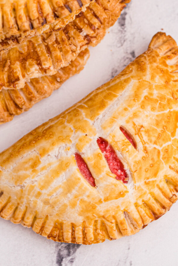 Cream Cheese Cherry pie made in the air fryer and on a white marble tabletop.