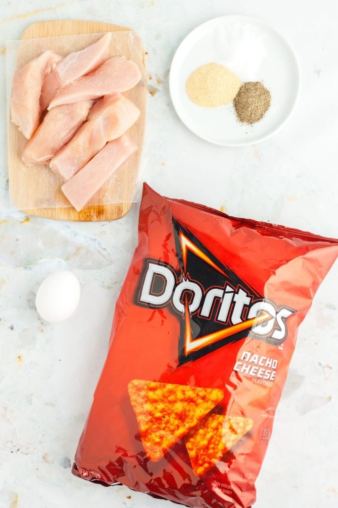 Ingredients needed to make Dorito chicken on a marble board