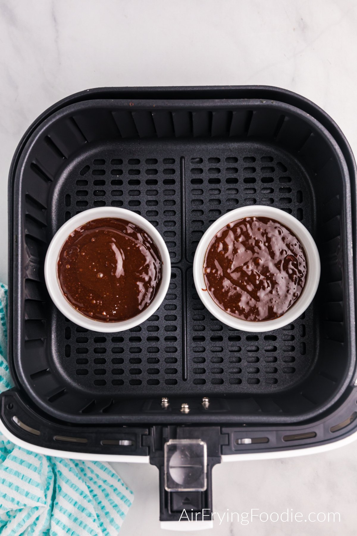 Chocolate batter poured into ramekins and placed into the basket of the air fryer.