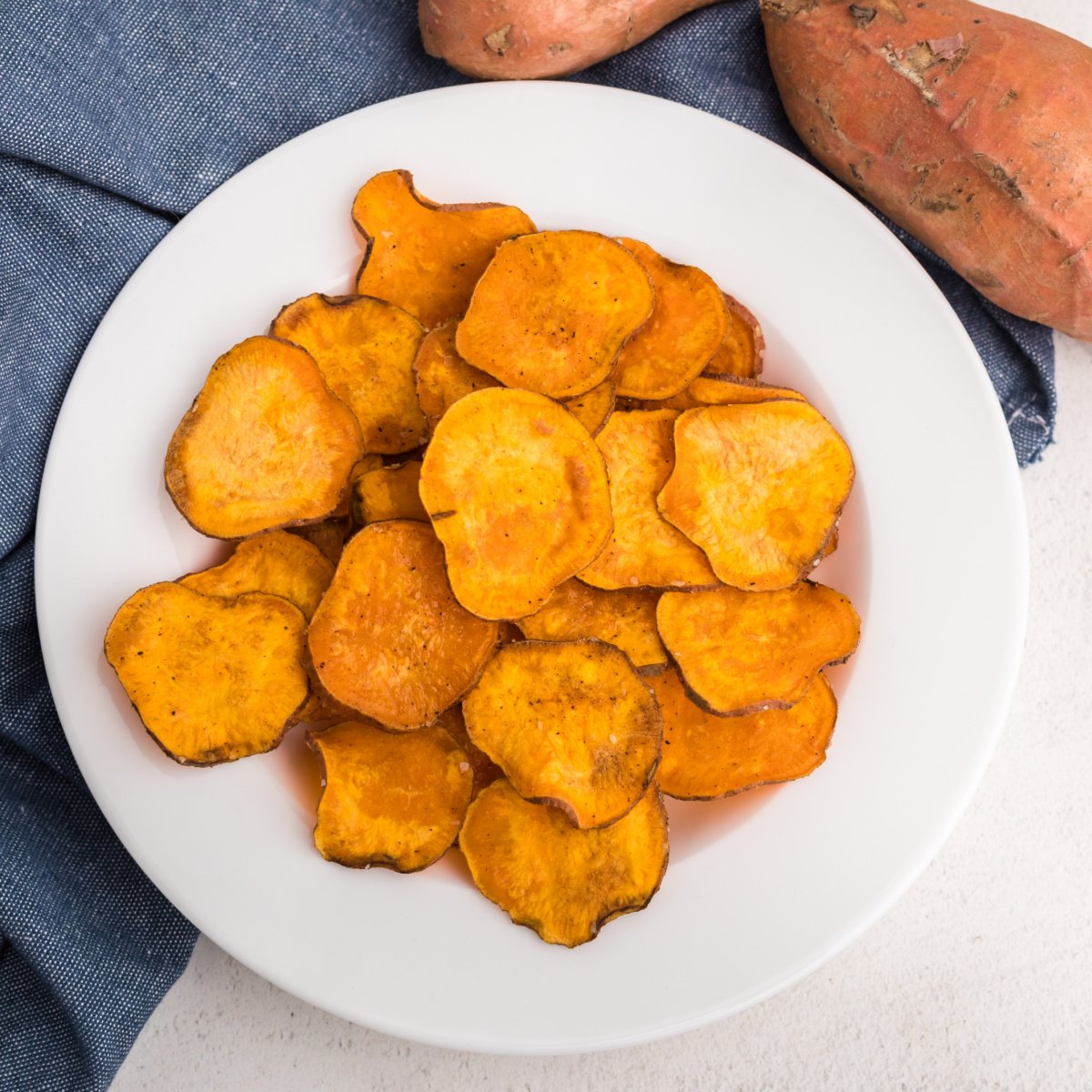 overhead photo of air fryer sweet potato chips in a white bowl.