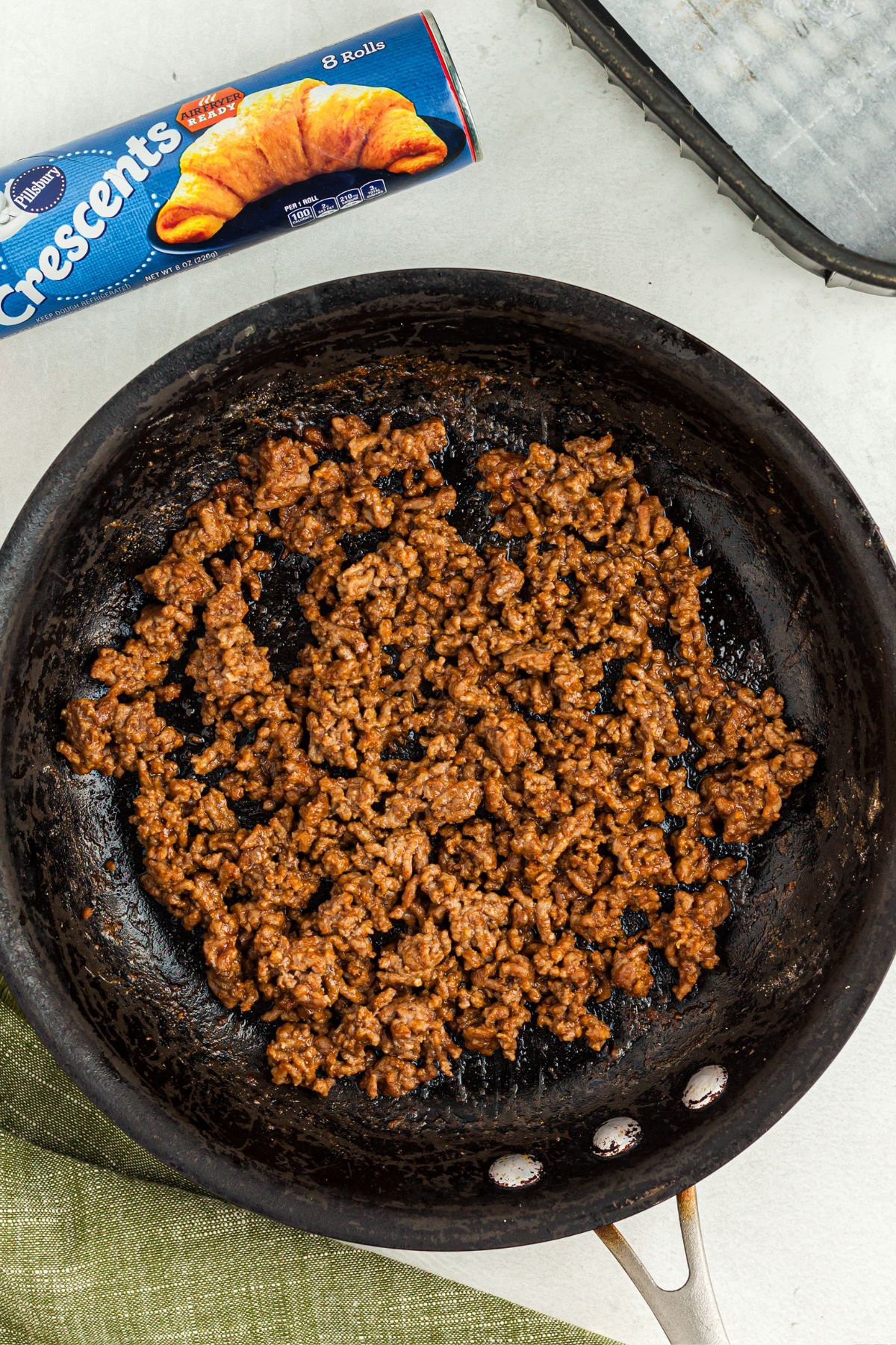 Cooked and seasoned taco meat in a skillet after being cooked