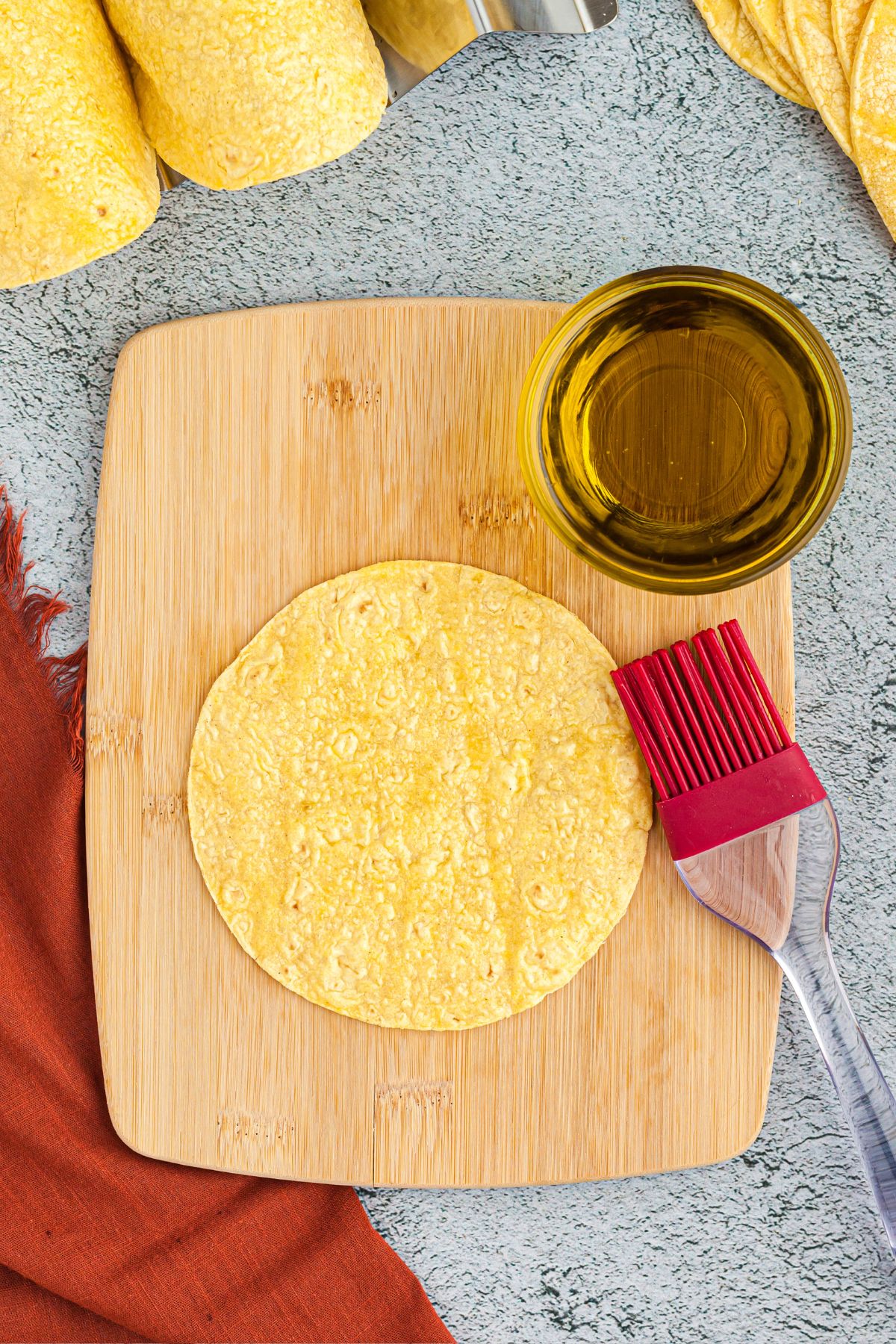 Brushing oil on tortillas and then draping over mold or foil to shape