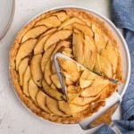 Air fryer apple tart with a slice of the tart ready to serve.
