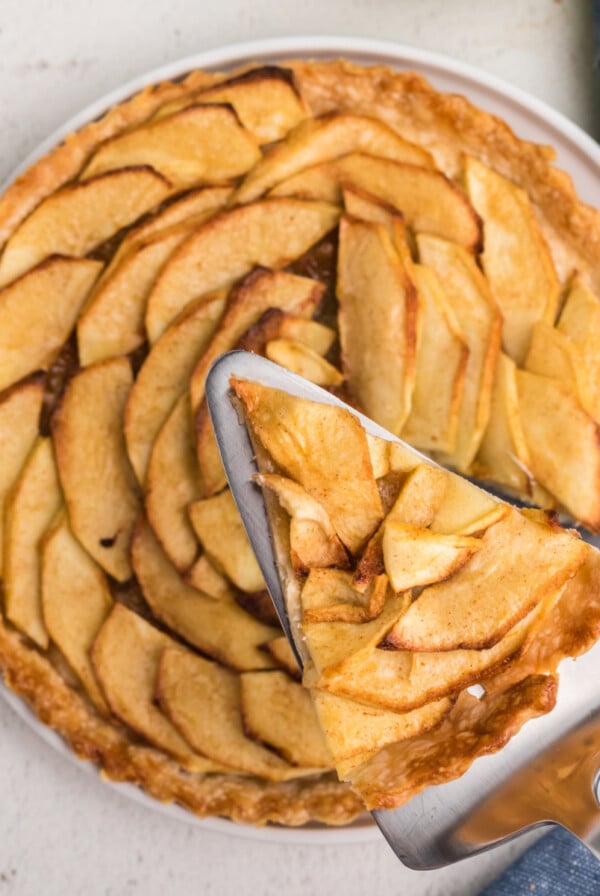 Air fryer apple tart with a slice of the tart ready to serve.