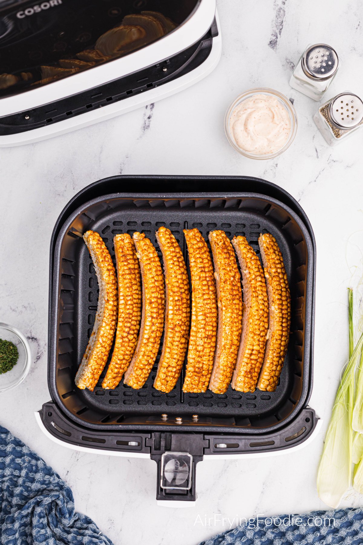 Corn ribs in the basket of the air fryer ready to cook.