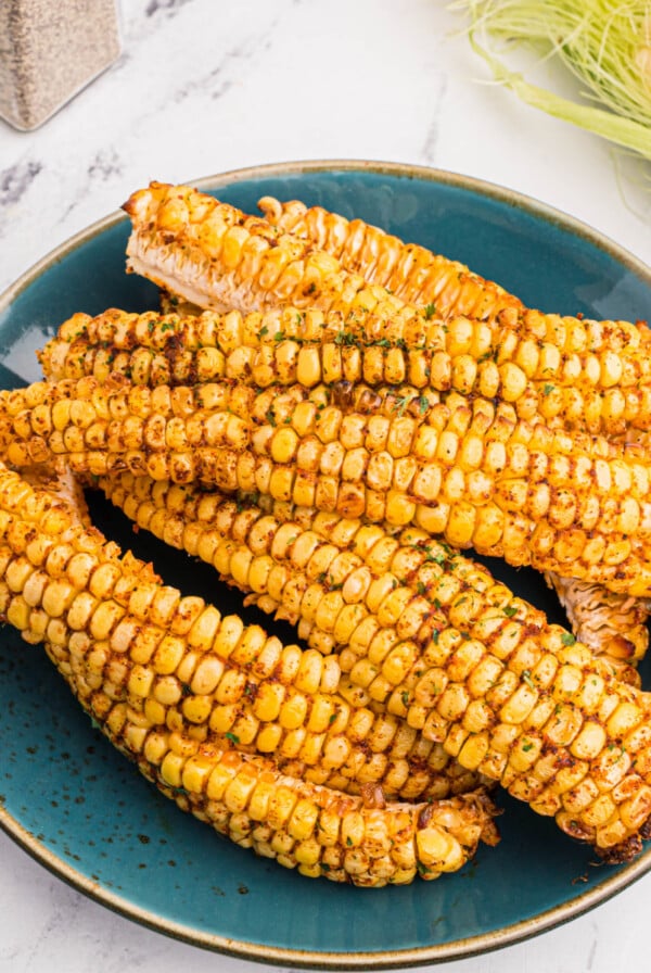 Corn ribs made in the air fryer, served on a blue plate.