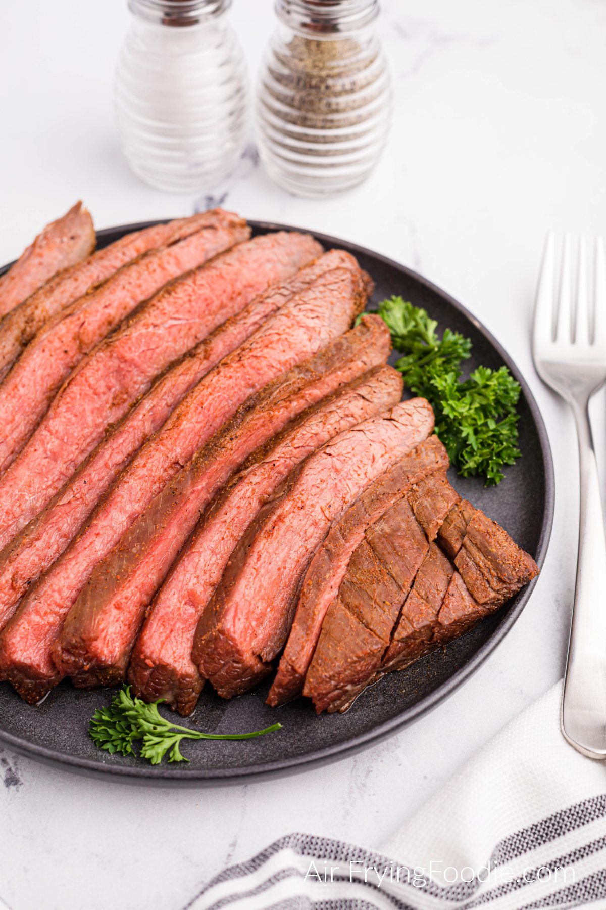 Flank steak served on a platter and ready to serve.