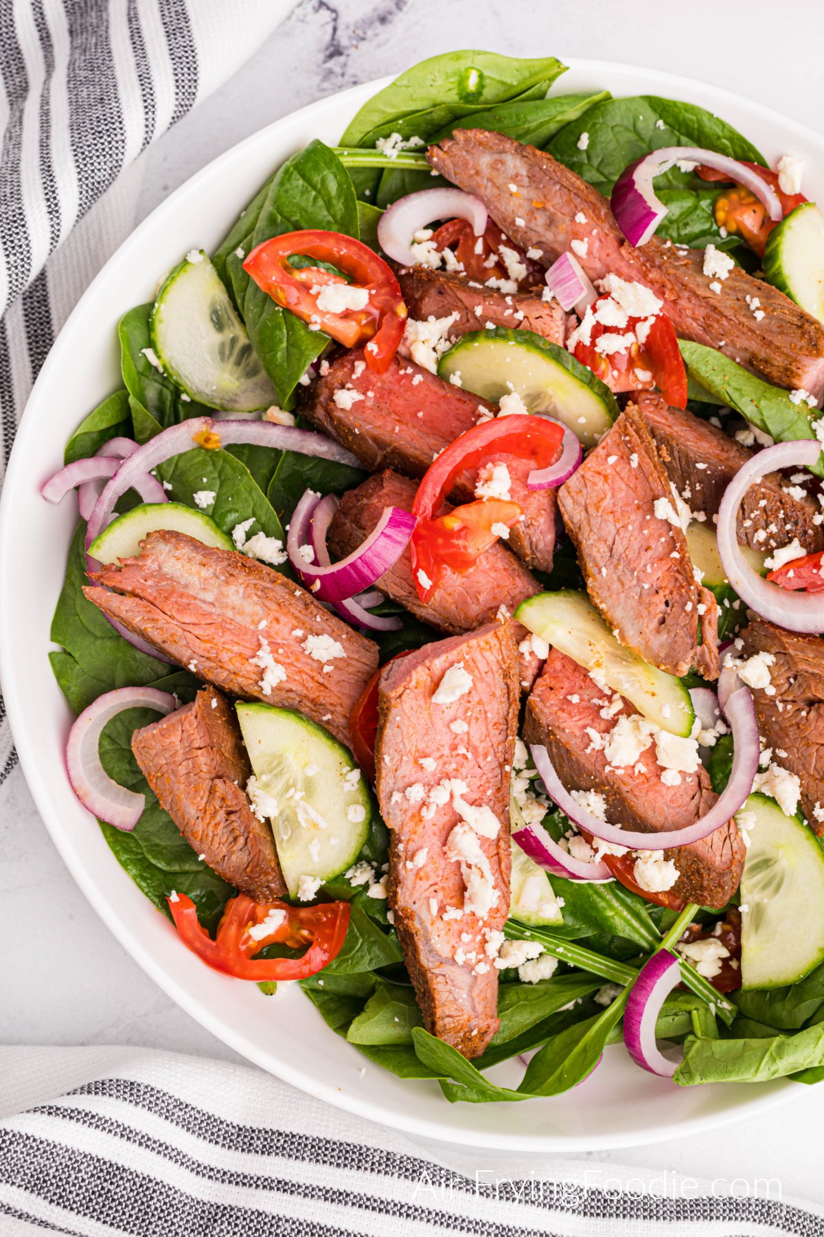 Air Fried Flank Steak sliced and served on a salad. 