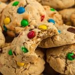 Monster cookie with bite taken stacked on other cookies