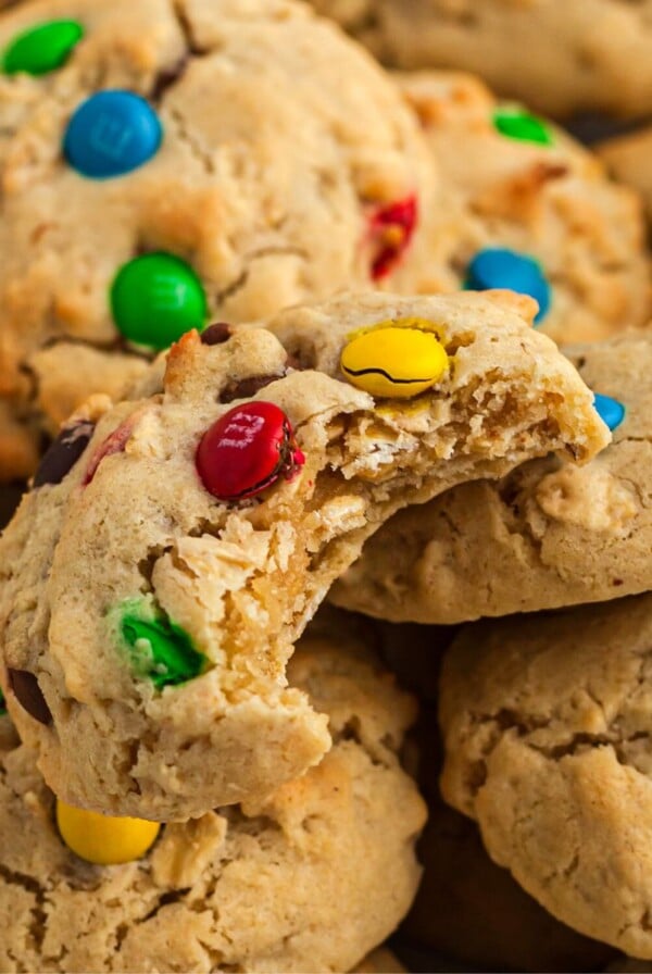 Monster cookie with bite taken stacked on other cookies