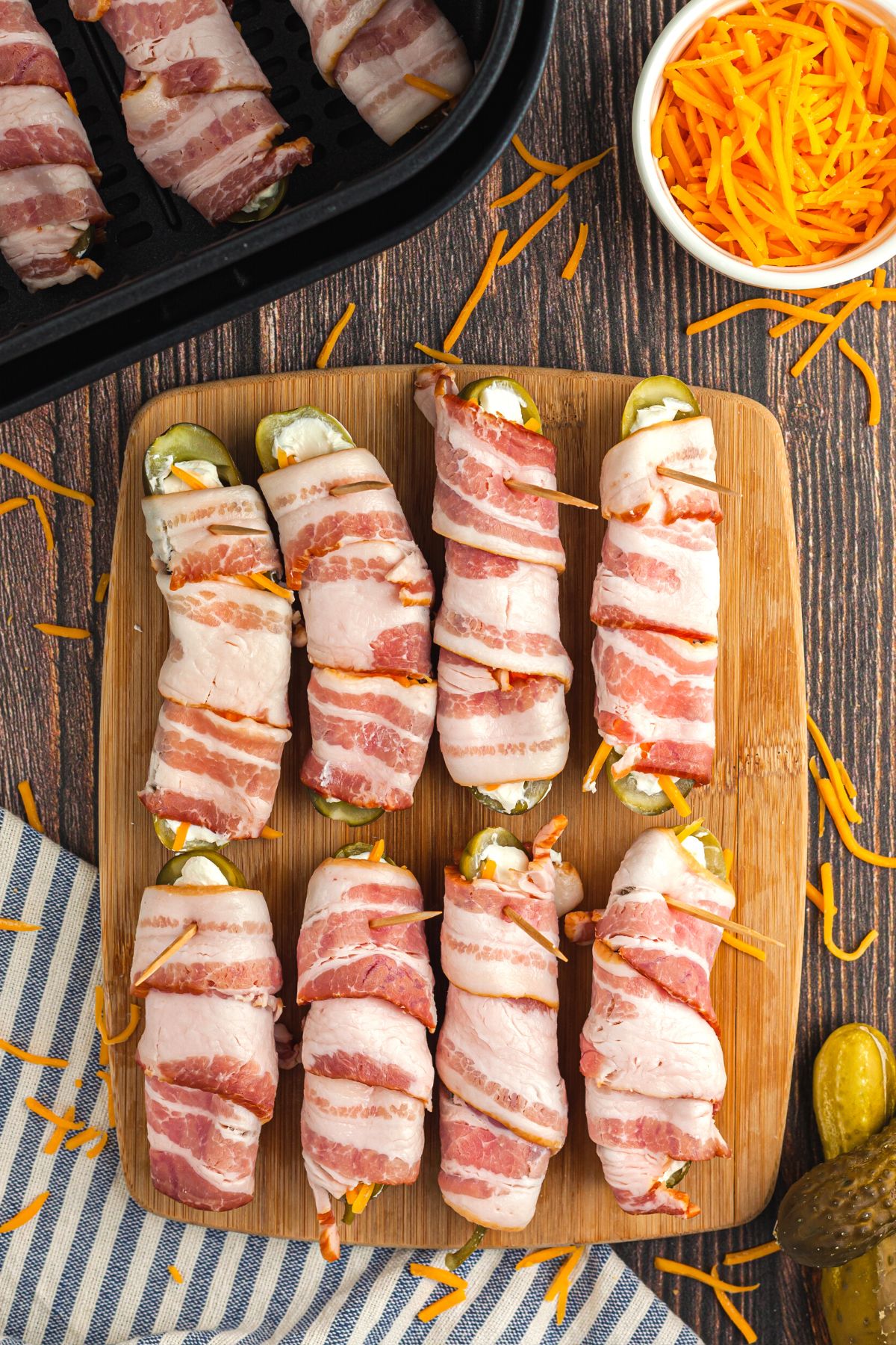 Pickle slices filled with cream and cheddar cheeses and wrapped in bacon slices