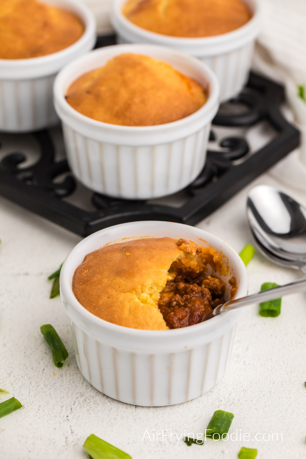 Chili pot pie made in the air fryer with a spoon inside, ready to eat.