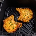 Golden crispy gluten free pork chops in the air fryer basket