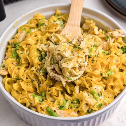 Golden cheesy pasta and chicken mixed in a casserole dish